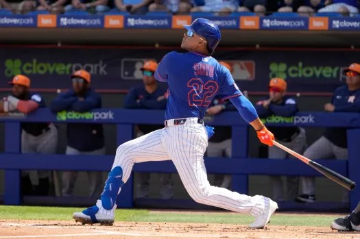 Juan Soto of the New York Mets swinging at the pitch, hitting a home run during spring training.